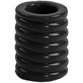 Black cylindrical cock cage with stacked ring design on a white background.