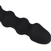 A black, ridged novelty toy with a rounded tip against a white background.