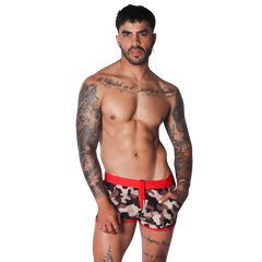Men's camo print beach shorts featuring a bold red elastic waistband, matching red trim, and a drawstring front.