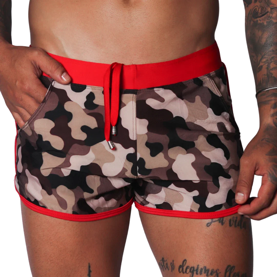 Men's camo beach shorts with red trim, drawstring waistband, and side pockets in a short athletic fit.