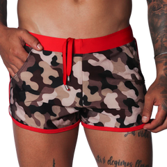 Men's camo beach shorts with red trim, drawstring waistband, and side pockets in a short athletic fit.