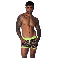 Men’s short camouflage print swim trunks with a bright neon yellow elastic waistband, trim, and front drawstring.