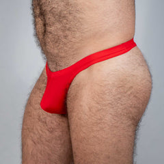 Red tulio swim thong in smooth stretchy fabric featuring a form-fitting design shown from the back side