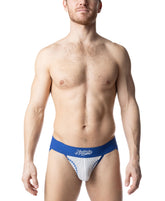A man wears Nasty Pig quartz blue and white jockstrap underwear with baseball-style stitching on a white background.