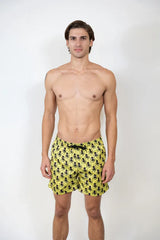 Bright yellow octopus print swim shorts with repeating black pattern perfect for beach and pool use
