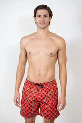 Red toucan print swim shorts with black and yellow abstract pattern perfect for swimming and beachwear