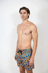 Men’s feather print swim short in vibrant blue and orange leaf pattern stretch fabric with black drawstring waistband