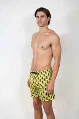 Bright yellow octopus print swim shorts featuring a repeating black octopus pattern for beachwear