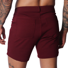 Wine-colored fitted shorts featuring a classic five-pocket design, belt loops, and smooth stretch fabric.