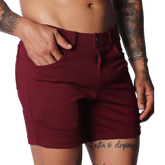 Wine-colored, short-length casual shorts in a smooth, stretch fabric with a button-fly closure and belt loops.