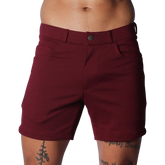 Wine-colored tailored shorts with a structured waistband, button closure, and classic five-pocket design.