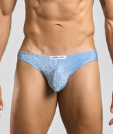 Light blue glittery men’s briefs with white justin plus simon brand tag from the classic mens bikini collection