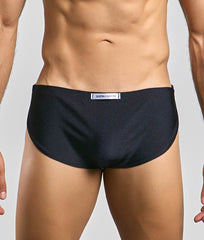 Black justin simon running short briefs with subtle textured fabric and white label at the waistband