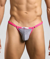 A vibrant pink and silver glitter thong bikini bottom with branded label from Justin plus Simon Bikini One