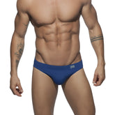 Blue men’s ad basic swim brief with subtle logo on waistband designed for comfortable swimming and beachwear