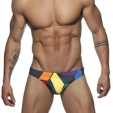 Vibrant geometric-patterned ad pride bikini swim trunks in bold rainbow hues designed for swimming and beachwear
