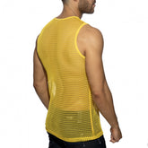 Rear view of a man wearing a yellow openwork mesh tank top against a white background.