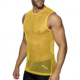 A man wearing a yellow openwork mesh tank top against a white background.