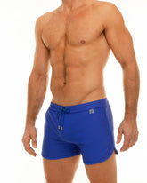 Along slit swim short bright blue swim trunks with drawstring waistband and side pockets for comfortable wear