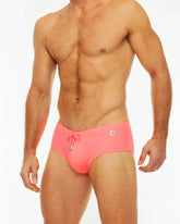 Bright pink along solid swim briefs with drawstring waistband and small front logo for swimming and beachwear