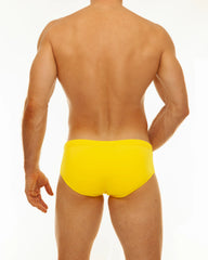 Bright yellow solid swim brief made from durable material designed for swimming and beach wear