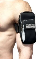 Black and gray sstricks arm bag with zippered compartments and reflective stripe for secure storage during activities