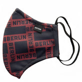Black and red patterned face mask with berlin text grid design and black elastic ear loops size one size