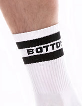White athletic sock with black ribbed cuff and bold bottom branding by barcode berlin in a sporty design size s/m