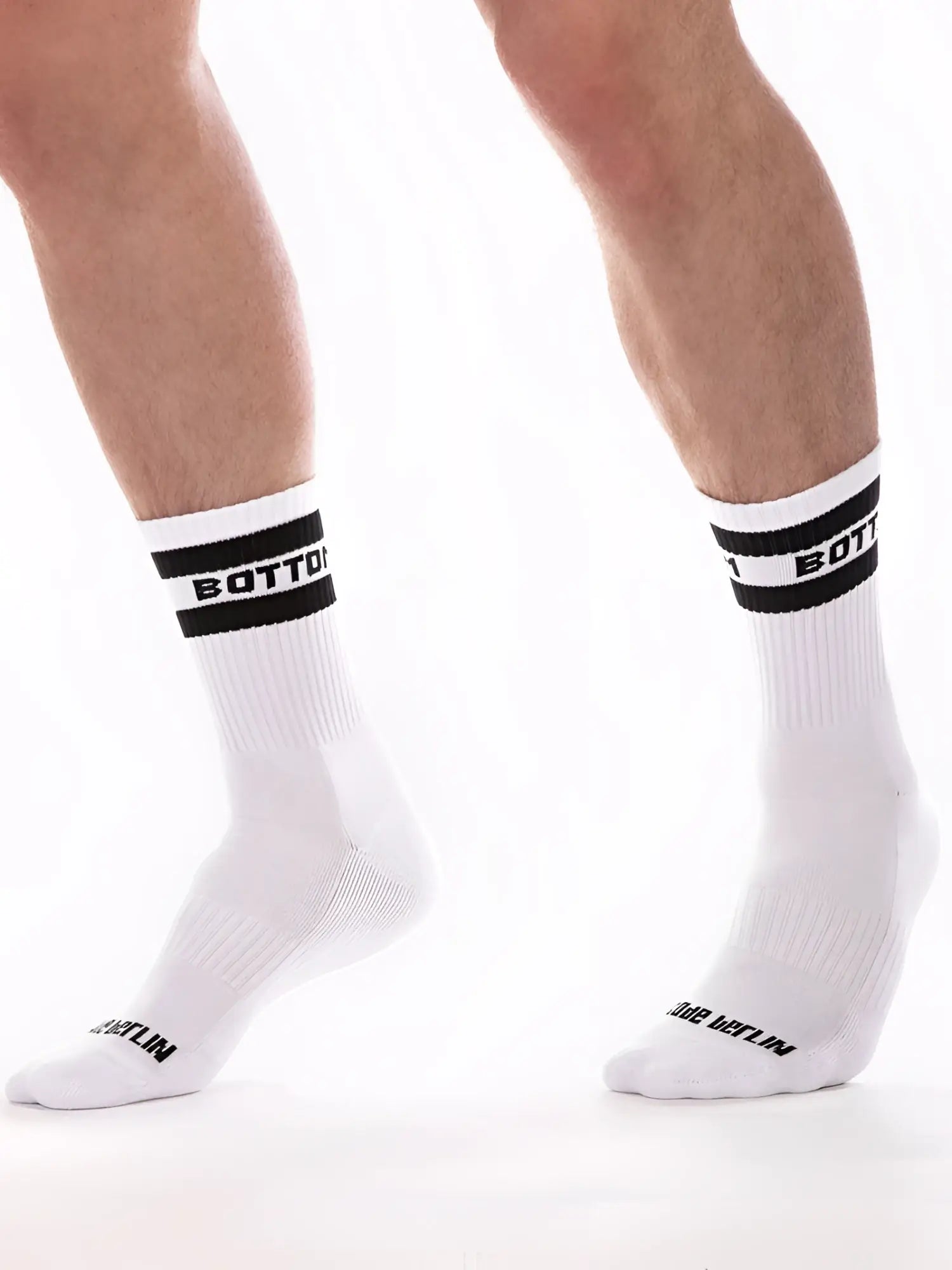 White crew socks with black ribbed cuffs and bold white bottom lettering by barcode berlin size s/m