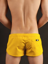 Bright yellow Barcode Berlin gym shorts with a sleek modern design and black brand tag on the back pocket shown from the back