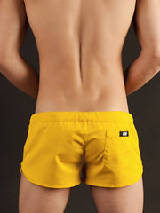 Bright yellow Barcode Berlin gym shorts with a sleek modern design and black brand tag on the back pocket shown from the back