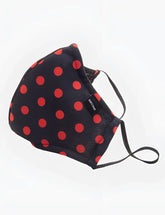 Black fabric face mask with bold red polka dots and black elastic ear loops from barcode berlin unisex one size