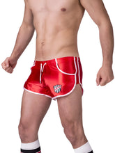Red satin athletic shorts with white trim and a black and white shield logo on the left leg size xl by barcode berlin