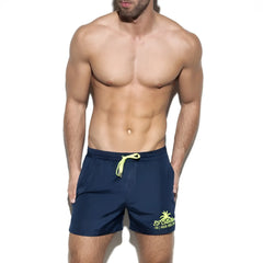 Basic boardshort navy blue swim trunks with neon yellow drawstring and palm tree logo on the side