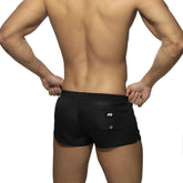 Back view of basic mini short black athletic shorts with a white logo on the back pocket for casual wear