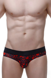 Black bikini briefs with vibrant red heart pattern in cotton fabric from Céron king of hearts collection
