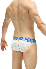White petitq bikini brief with colorful candy cane pattern and blue waistband featuring petitq logo for covid vaccine use