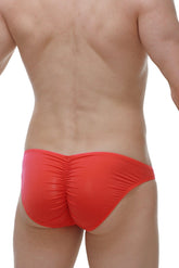 Bright red ruched swim trunks with a sleek form fitting design from petitq bikini prulhé plum crimson collection