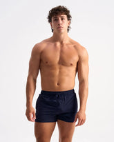 Navy blue bolt 3 inch short athletic swim trunks with drawstring waistband designed for active swimming
