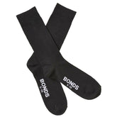 Black cotton bonds everyday oxford crew socks size 6-10 showing white branding on heel back side view