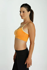 Orange sports bra top with cream trim and thin straps designed for activewear and comfort