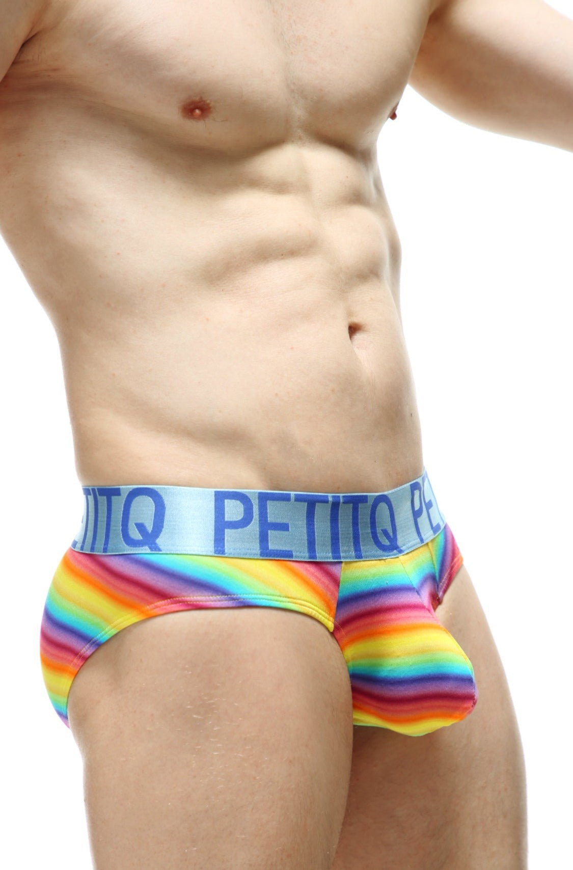 Rainbow-striped men’s briefs with light blue elastic waistband featuring petitq brand name in bold navy lettering