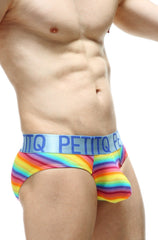 Rainbow-striped men’s briefs with light blue elastic waistband featuring petitq brand name in bold navy lettering