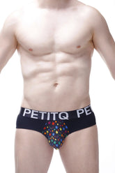 Black men’s briefs with colorful star pattern and petitq branding on waistband in brief stars rainbow design