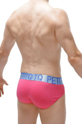 Bright pink modal briefs with light blue x-cross elastic waistband featuring petitq logo in repeating lettering