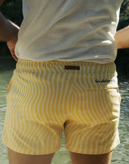 Byron swim short in dolce yellow with white wavy stripes and a brown leather la dolce vita brand tag