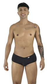 Model poses wearing black CandyMan trunks with a low-rise, form-fitting cut against a plain white background.