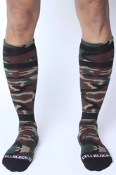 CellBlock 13 Foxhole knee-high socks in camouflage pattern with black ribbed cuffs and toe caps in green brown beige tones