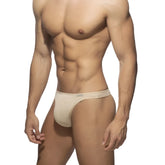Beige cotton thong briefs with a snug form fitting design for comfortable everyday wear
