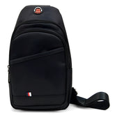 Black nylon crossbody sling bag with red and white circular logo and small flag emblem on front